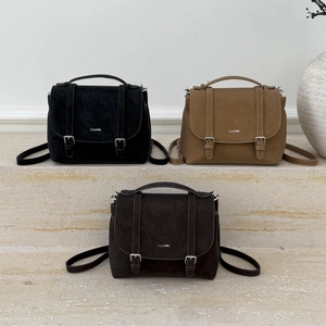 Trio of retro matte leather backpacks in black, khaki, and brown with buckle details