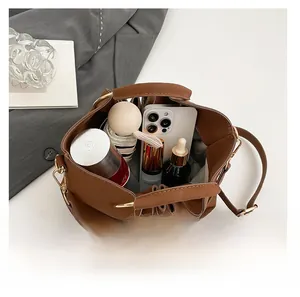 Interior view of brown PU bucket bag showing large capacity for phone and cosmetics