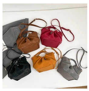 Top view of slouchy tote bags in five colors with metal handles and pleated design