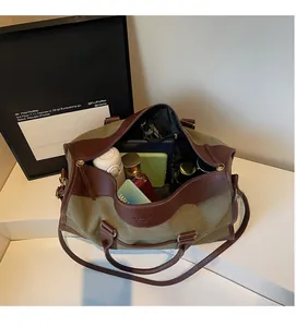 Macro view of canvas travel bag interior with organized items and leather trim