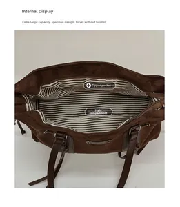 Detail view of suede tote interior with striped lining and secure zippered pocket