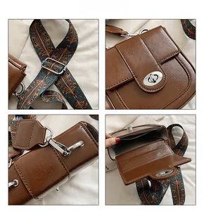 Detail view of brown saddle bag featuring silver twist lock and bohemian woven strap