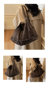 Detail of dark brown faux suede shoulder bag with decorative straps and silver buckles
