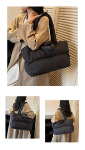 Detail of black quilted puffer tote bag with padded shoulder straps and spacious design