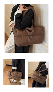 Detailed view of brown puffy quilted tote bag showing soft texture and large capacity