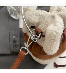 Macro shot of high-quality silver metal hardware on a plush lamb wool bucket handbag