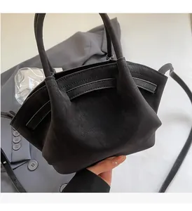 Detailansicht der weichen, mattschwarzen Hobo-Tasche mit Rundgriffen und Gurt