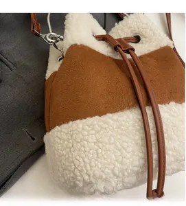 Detail shot of white faux shearling and brown suede fabric with drawstring closure