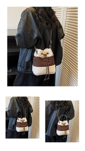 Detail of suede and plush bucket bag with metal handle and drawstring closure