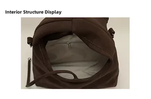 Detail view of the brown suede shoulder bag internal structure with zipper pocket