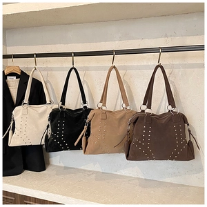 Detail view of four large rivet tote bags in beige, black, khaki, and dark brown colors