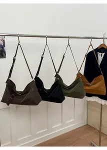 Detailed row of vintage hobo tote bags showing different colors and side buckle accents