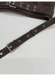 Close-up of adjustable dark brown leather shoulder strap with silver metal buckle