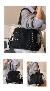 Close-up of silver studs and ring detail on a black suede texture tote bag