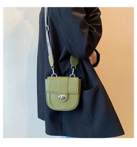Detail of olive green saddle bag showing litchi texture and silver twist lock