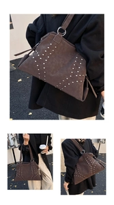 Detail of coffee brown suede tote bag featuring metallic stud accents and silver ring hardware