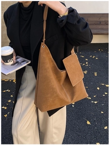 Detailed view of dark brown suede tote bag with side pocket and minimalist shoulder strap