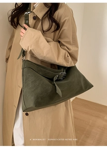 Detail of dark moss green suede hobo bag with adjustable silver buckle strap