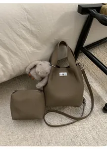 Detail of lychee pattern leather bucket bag with inner pouch and bunny charm