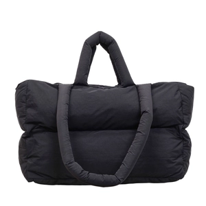 Black padded puffer tote bag with quilted texture and matching shoulder strap for women