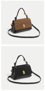 Detail view of quilted dual-texture handbag featuring gold metal clasp and top handle