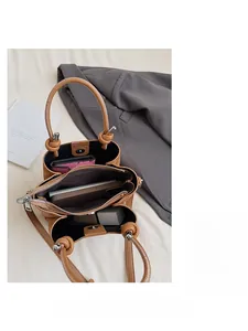 Detail view of the brown litchi leather handbag showing multi-compartment interior space