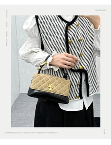 Detail showing contrast stitching, quilted texture, and golden clasp on retro handbag