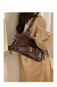 Detail view of retro brown oil wax leather tote bag with metallic buckle and zippers