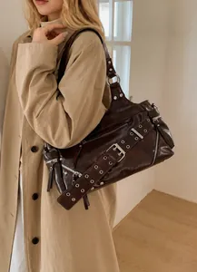 Detail view of deep brown oily leather shoulder bag with vintage silver metal hardware