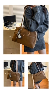 Detail of brown vintage tote bag showing decorative white stitching and heart leopard charm
