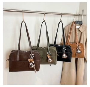 Detail view of four retro tote bags in coffee, green, black, and brown with heart charms
