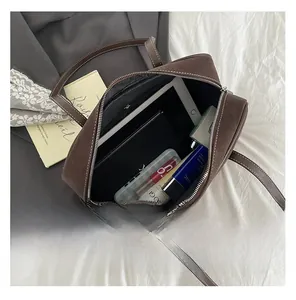 Interior view showing the large capacity of the brown tote bag with daily essentials