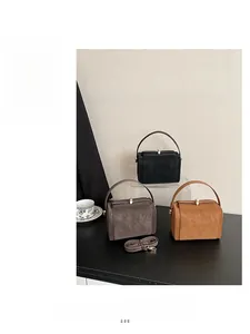 Chic solid leather tote bags in black, gray, and tan with top handles and metal buckles