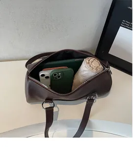 Interior view of brown Boston bag showing high capacity for phones and umbrellas