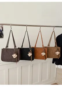 Detail view of woven handles and plush puppy charms on various colored tote bags