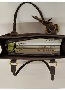 Deep brown tote bag with woven handle showing spacious interior for books and items