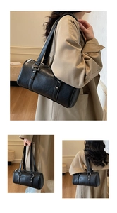 Detail showing high-quality black leather texture and silver hardware on a Boston bag
