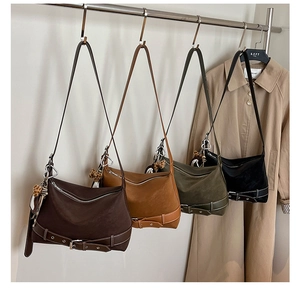 Detail view of vintage tote bags with leopard fur ball charms and decorative belts