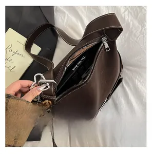Top view of spacious interior of brown vintage shoulder bag with leopard heart charm