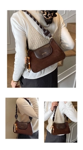 Detail of vintage brown patchwork shoulder bag with leather woven strap and beads
