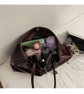 Detailed top view of a large vintage leather tote bag showing spacious interior capacity