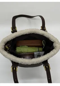 Deep brown leather shoulder bag interior showing large capacity for umbrella and items