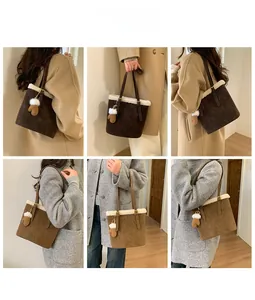 Detail of color-block suede bucket bag with faux fur trim and mitten charm accessory