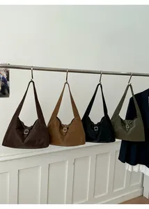 Row of minimalist suede hobo bags in coffee, brown, black and olive with silver buckles