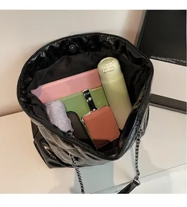 Interior view of black quilted tote bag showing space for tablet and daily items
