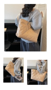 Detail of quilted leather tote bag with chain strap and shiny beige finish texture