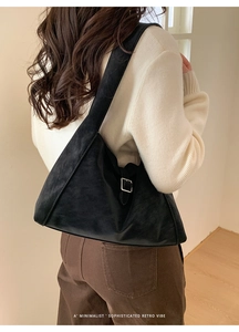 Suede texture black hobo shoulder bag shown on model with minimalist retro aesthetic