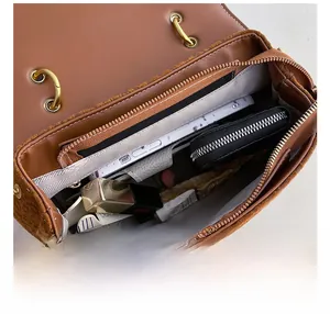 Macro view of brown leather shoulder bag interior showing large capacity for essentials
