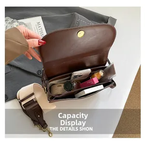 Internal view of brown flap bag showing large capacity for daily essentials and cosmetics
