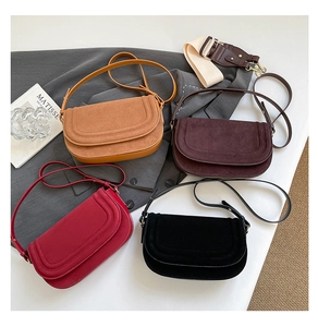 Flat lay of small crossbody bags in suede and leather with versatile shoulder straps